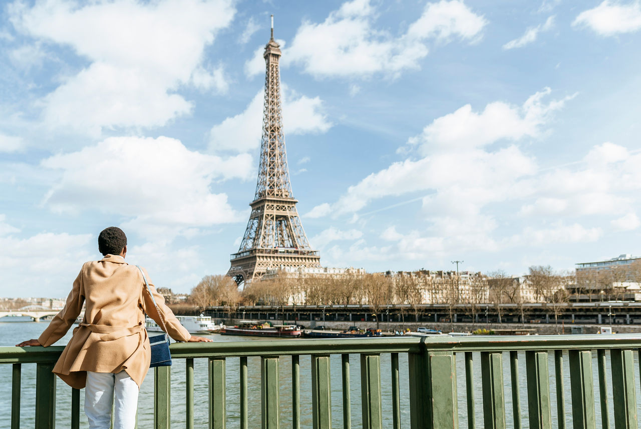France- Paris- Female tourist looking towards the Eiffel tower and the Seine river