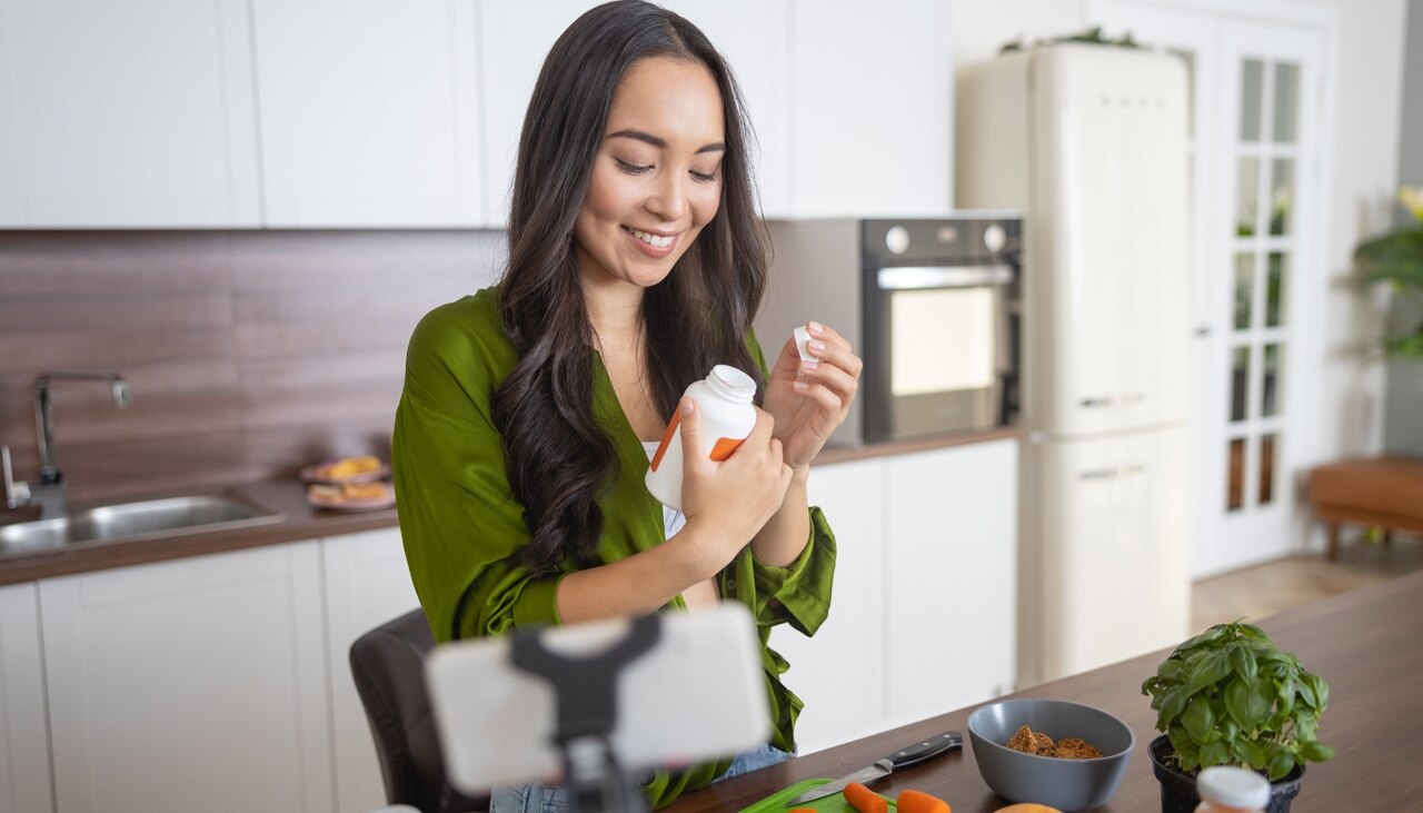 Health blogger unscrewing a plastic cap in front of the camera