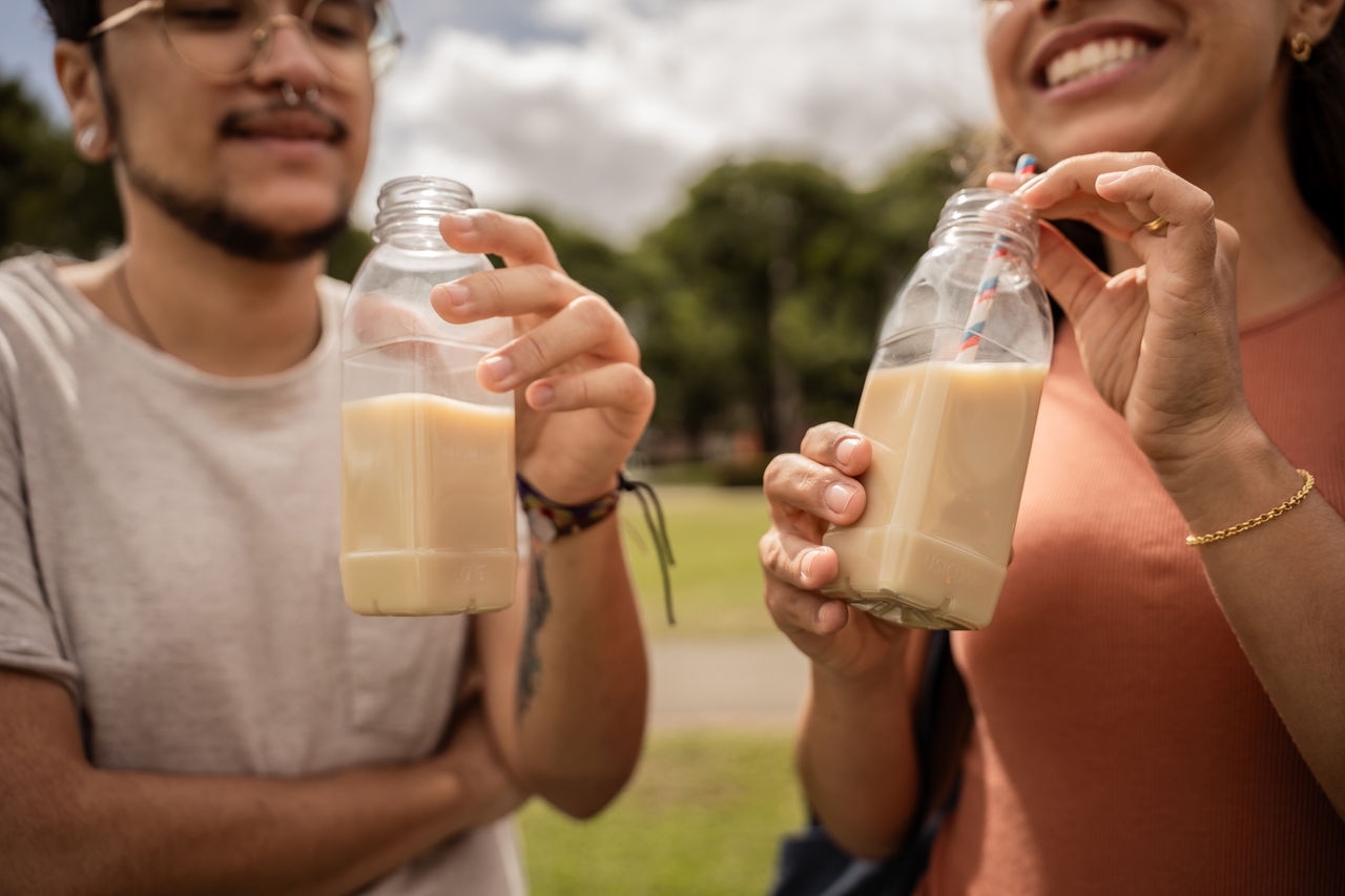 Thirteen friends drinking soy juice in the park