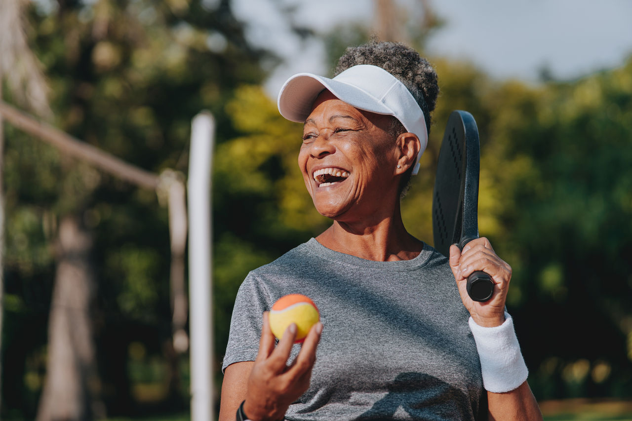 Portrait senior woman beach tennis