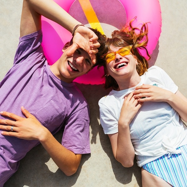 Couple lying with bathing suit on the floor