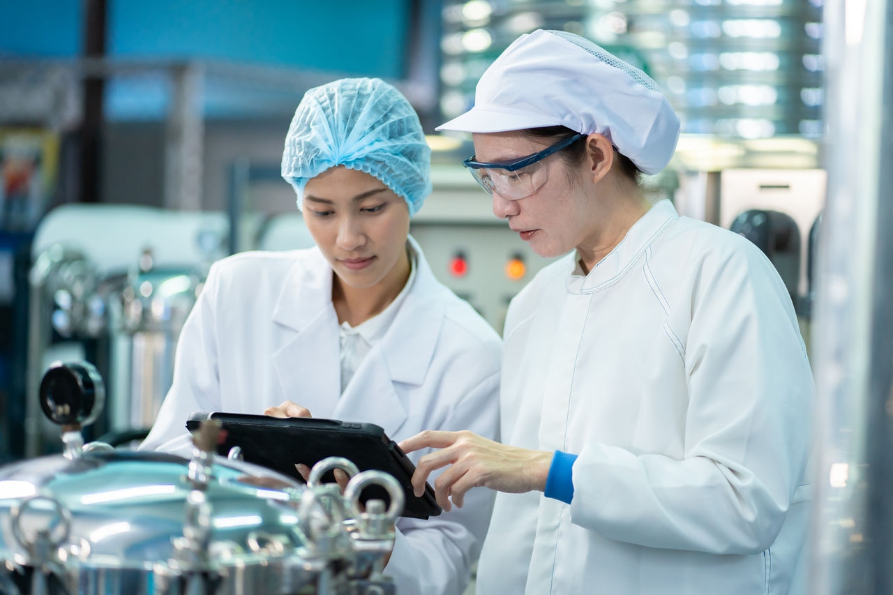 Asian woman teaching team work in working on food and beverage safety.