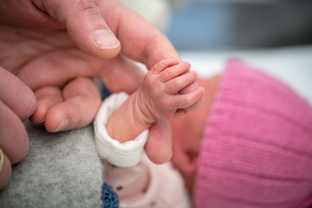 Holding a baby hand