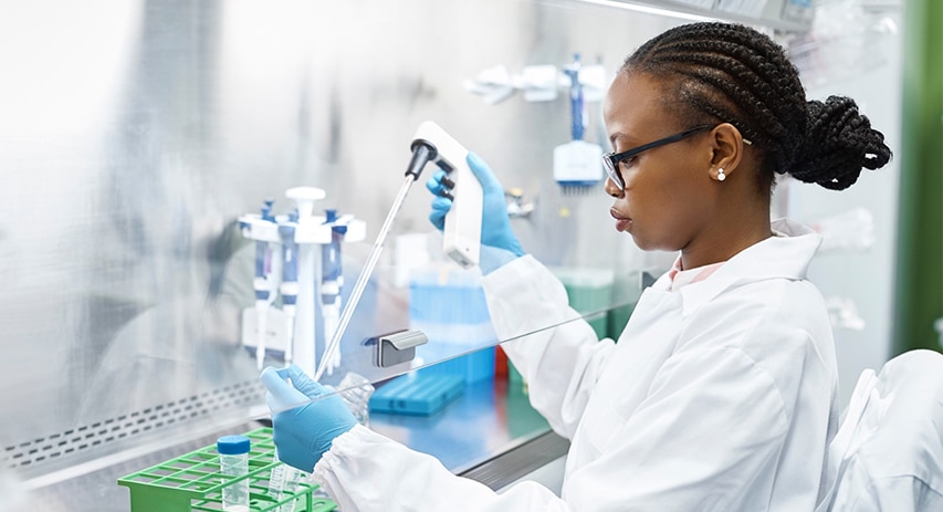  Female scientist extracting substance from test tube