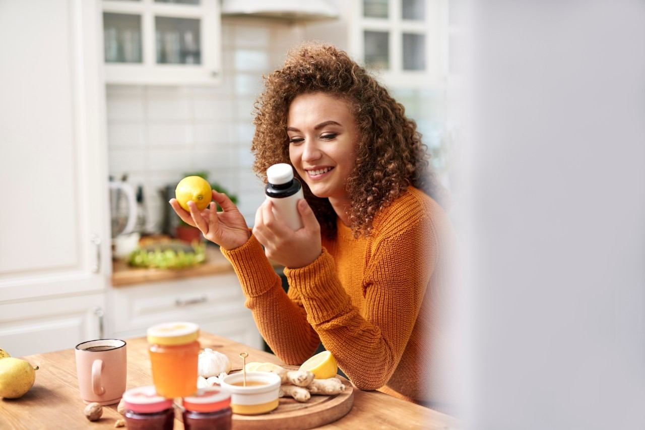 Woman with orange and vitamins 