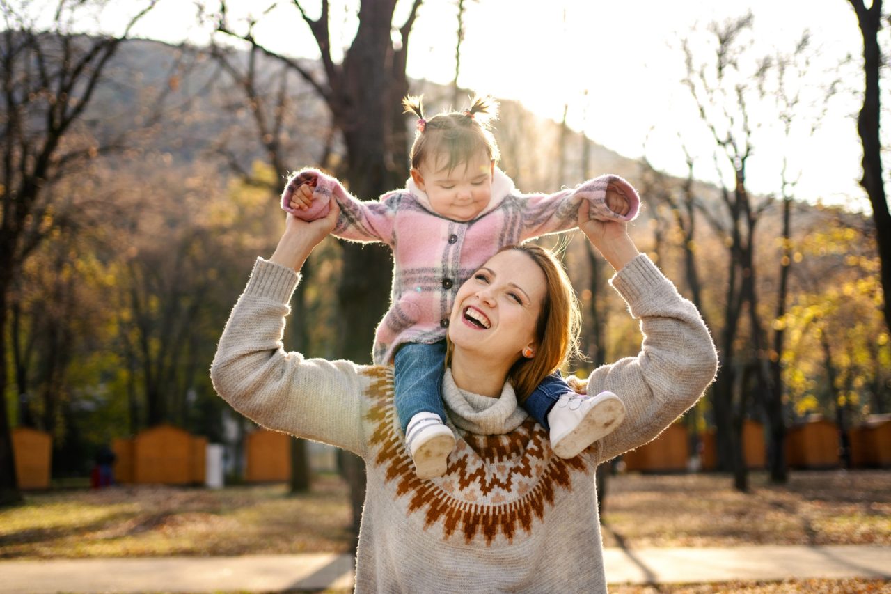 Mother with daughter in autumn park