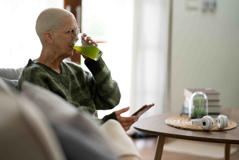 woman drinking a green beverage