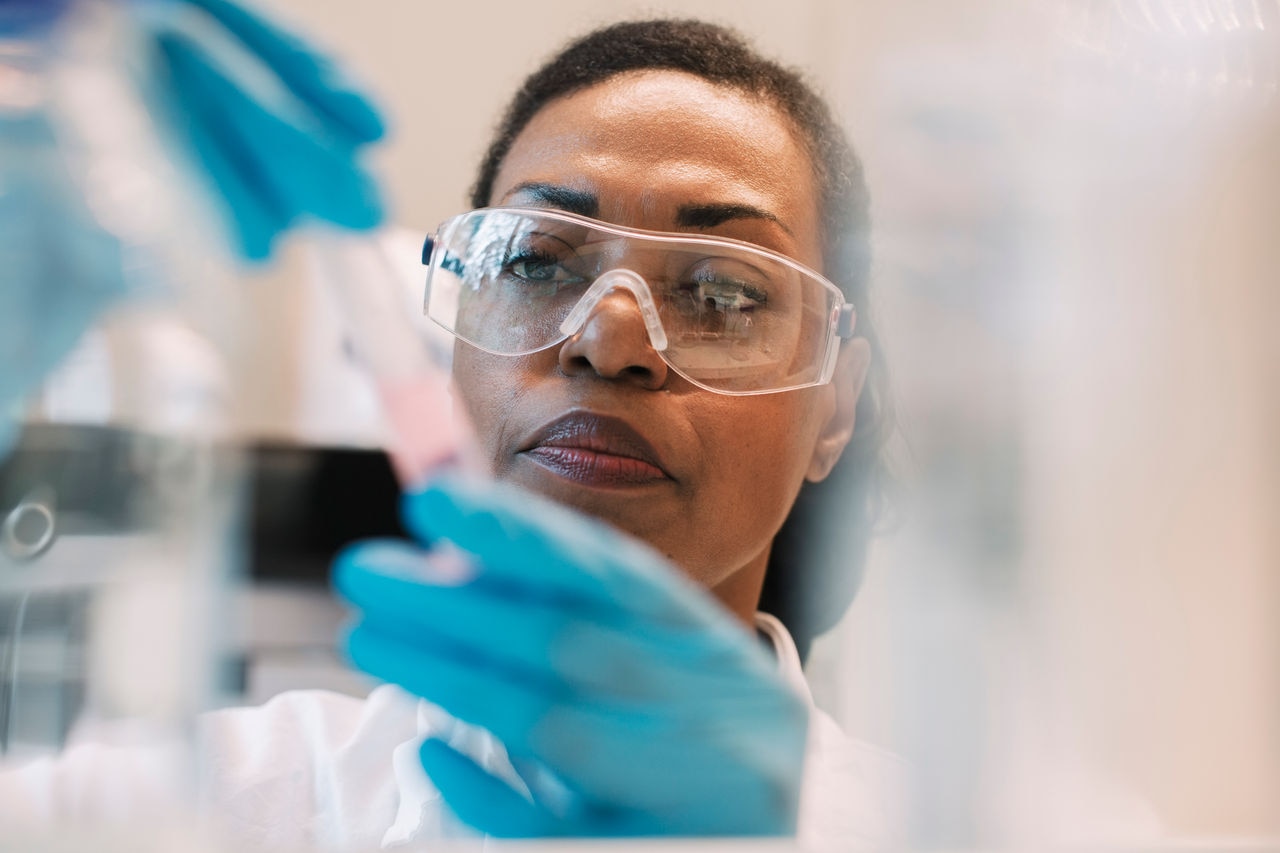 Female scientist checking a test tube in a lab