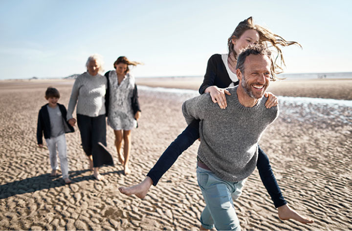Family playing happily in the beach