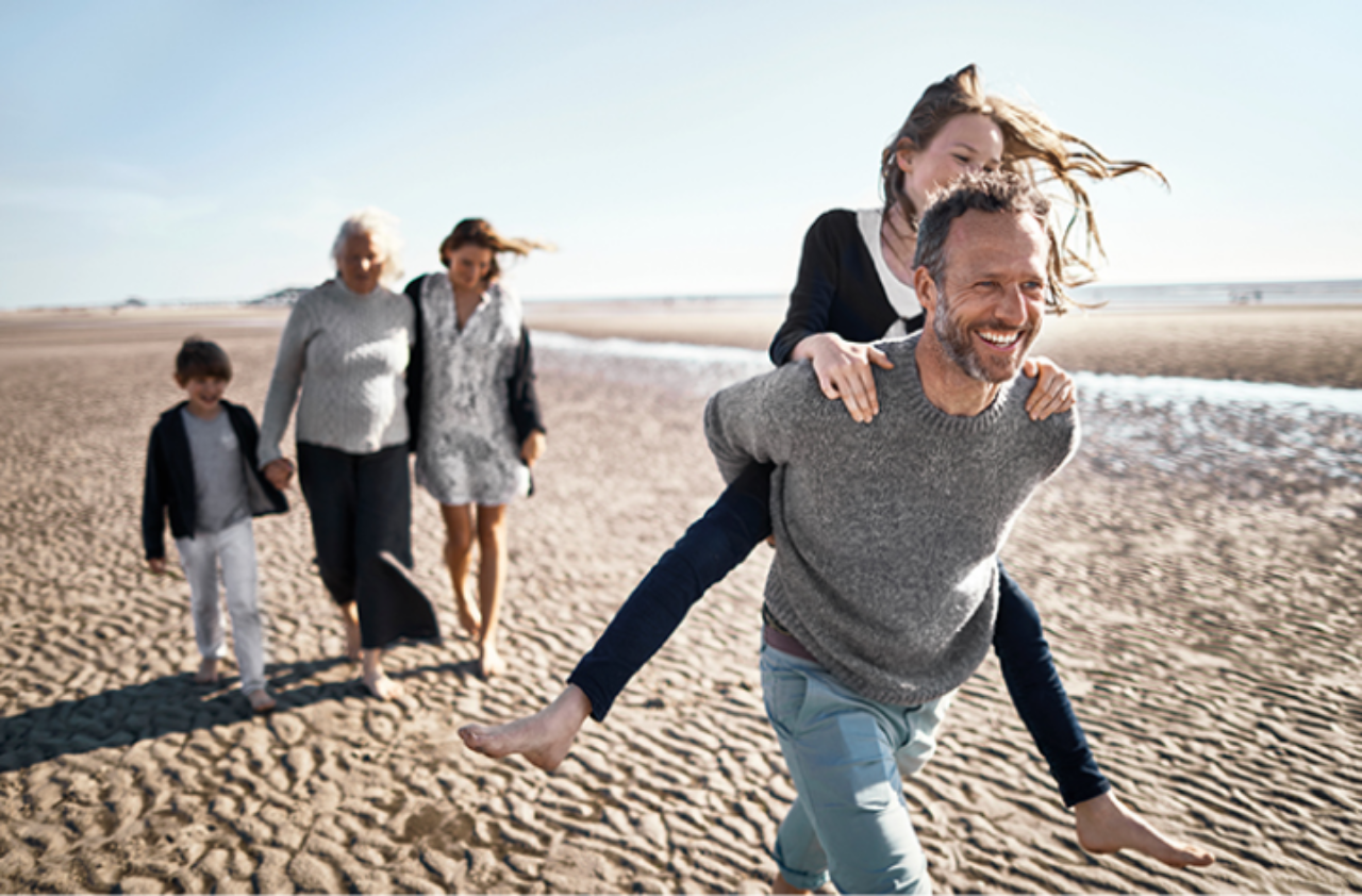 Family playing happily in the beach