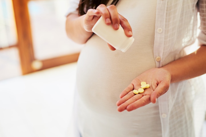 Pregnant woman taking pills