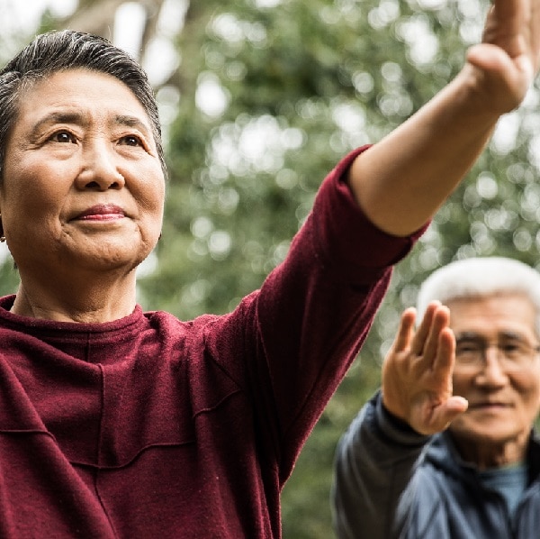Senior couple doing Tai Chi outdoors