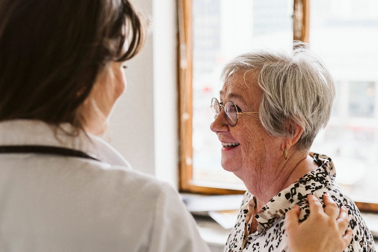 Doctor talking with senior female patient