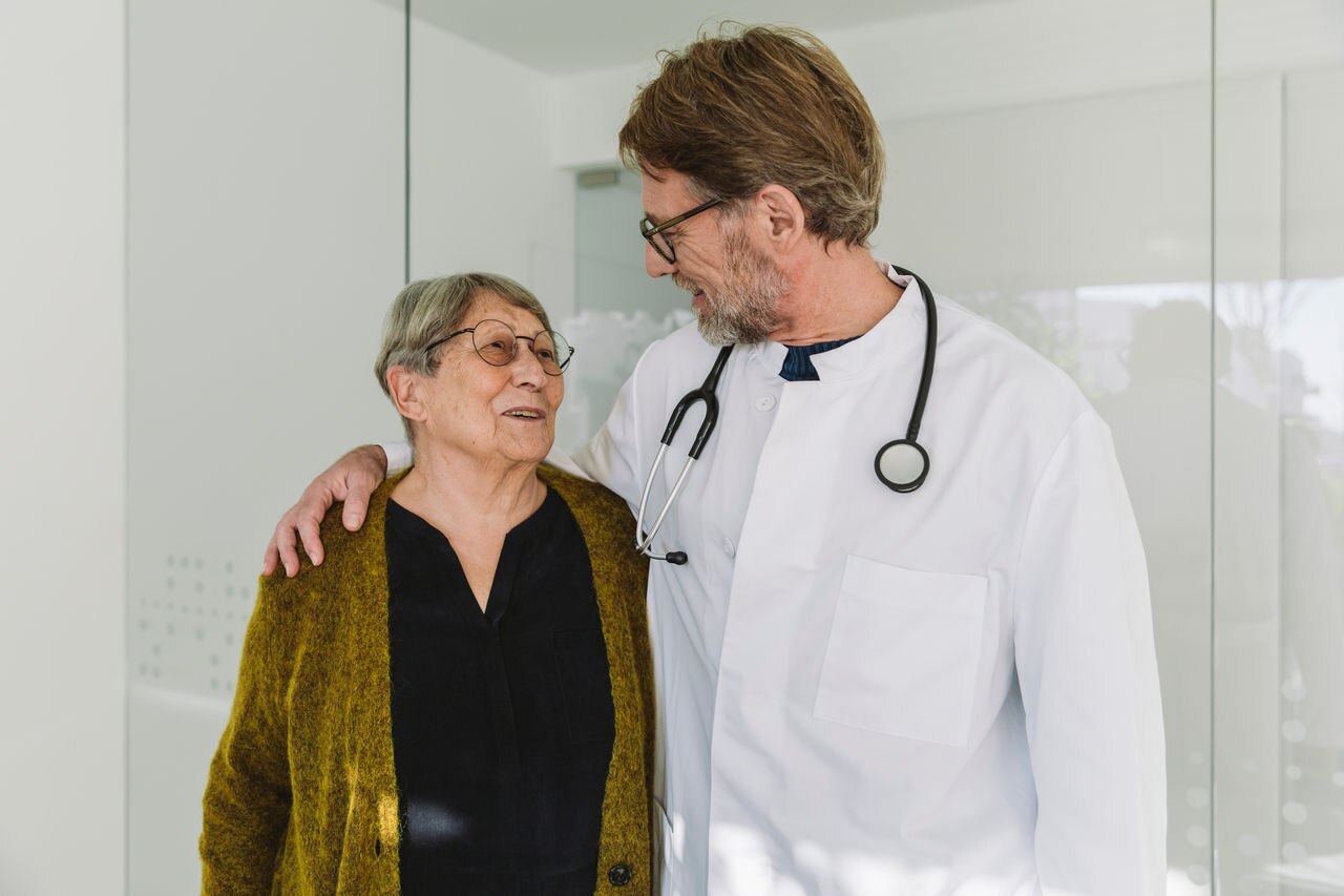 Doctor speaking to senior patient in his practice, Cologne, NRW, Germany
