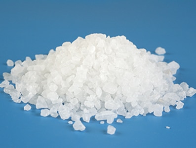 A heap of sea salt with shallow depth of field.