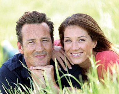 Loving couple laying in country field