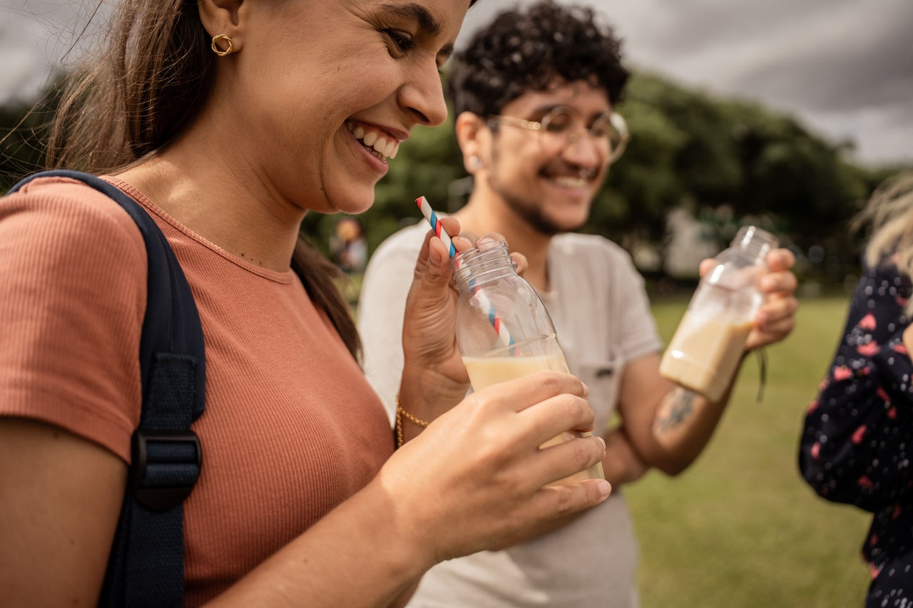 Thirteen friends drinking soy juice in the park