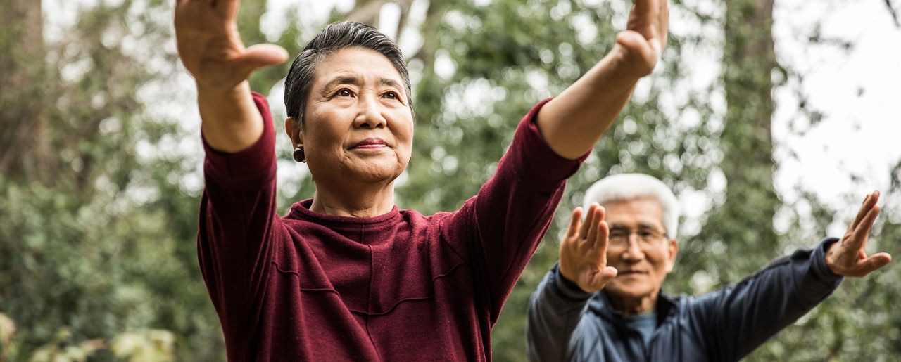 Senior couple doing Tai Chi outdoors