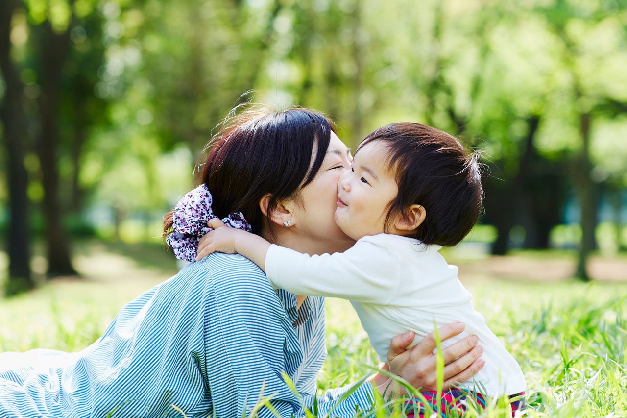 Asian mother and Baby boy on grass
