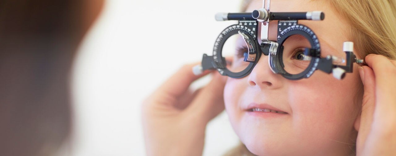 Eye doctor examining girl's vision