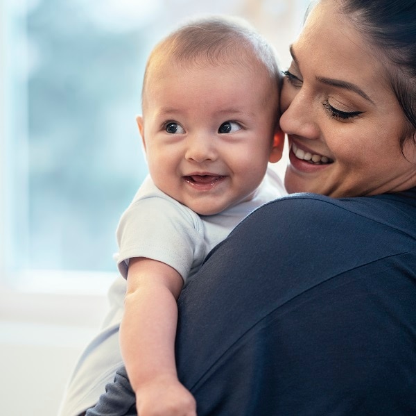 Mother and baby boy playing at home