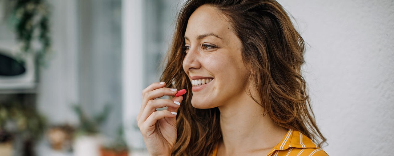 Young adult takes supplements at home