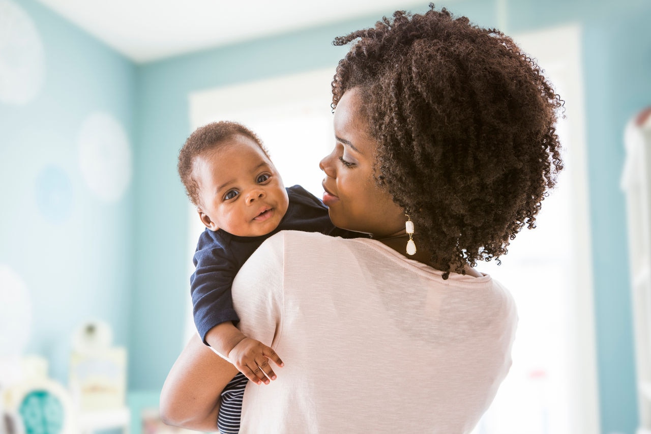 Black mother carrying baby son