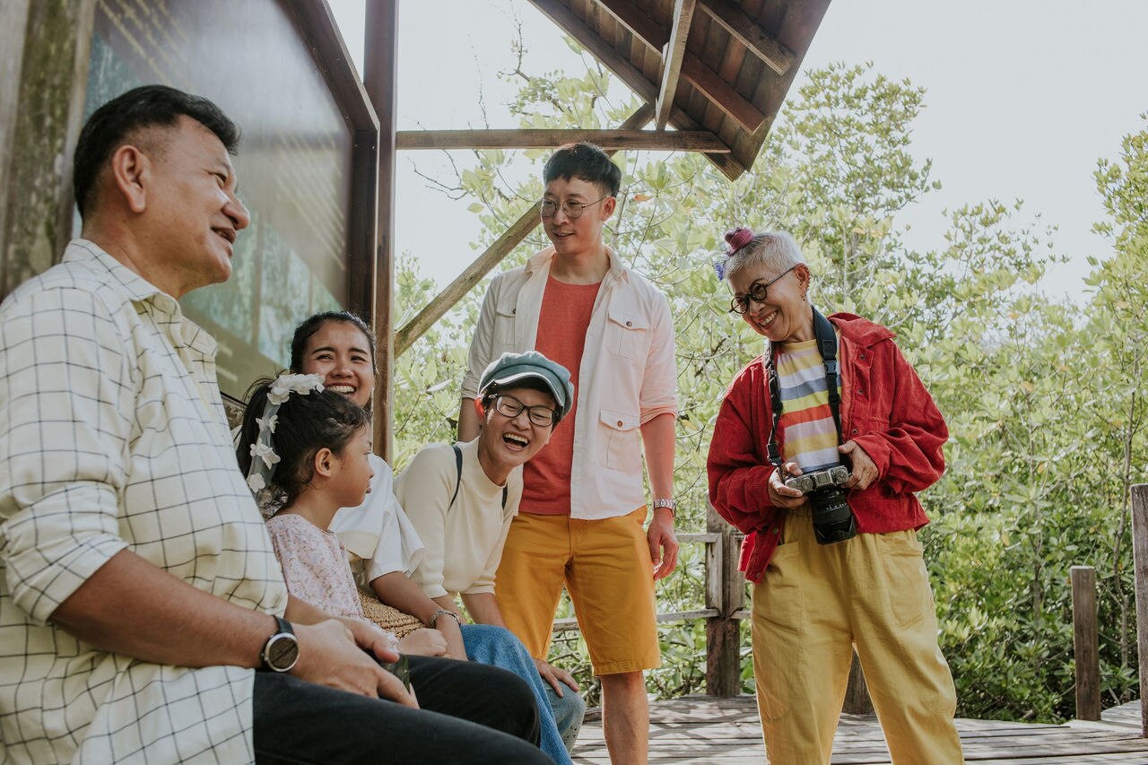 Thai large family laughing with a question that little girl asking about a mangrove forest while they visit