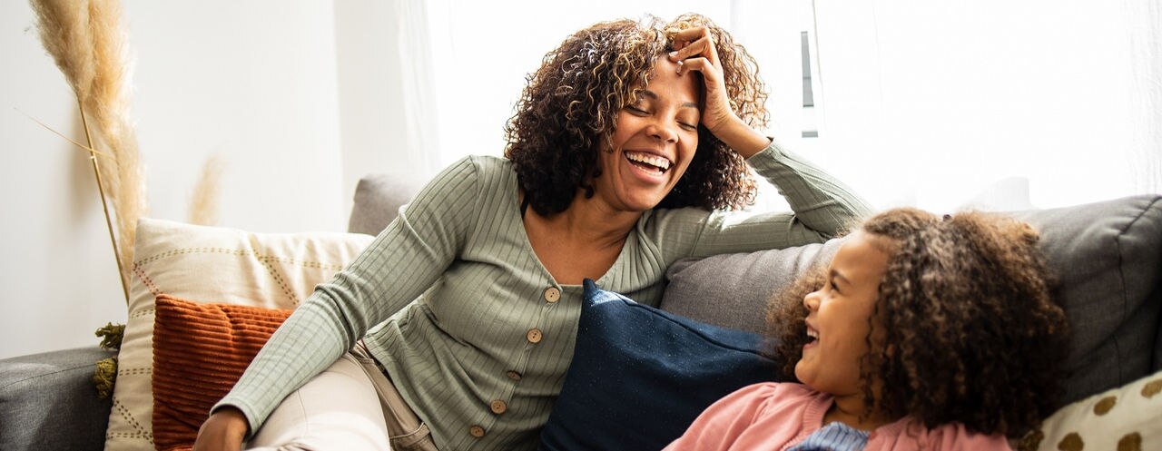 Mother and daughter having fun in the living room