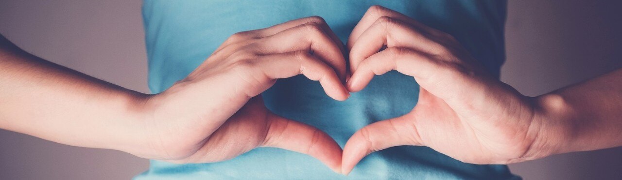 Woman hands making a heart shape on her stomach, healthy bowel digestion, probiotics  for gut health