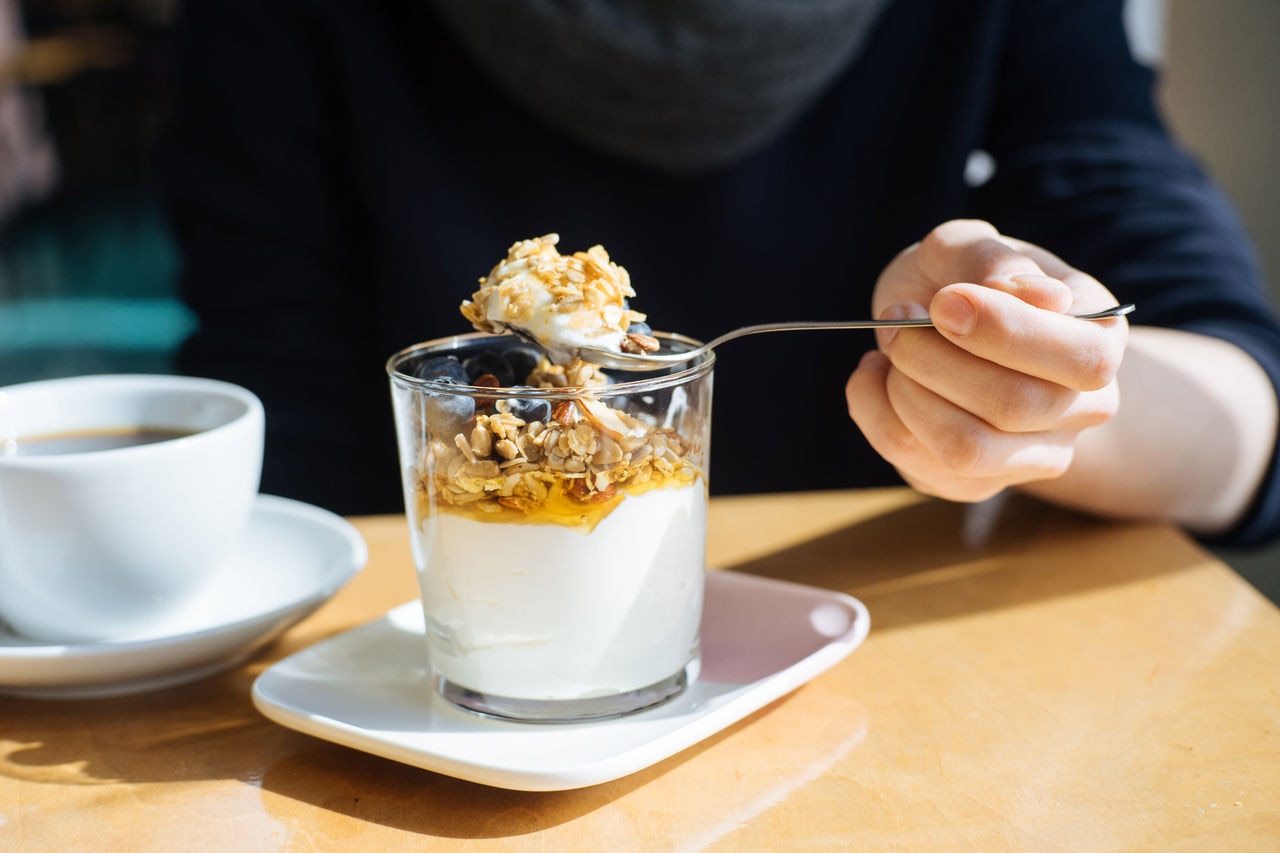 Granola with yogurt, berries, and honey breakfast, in cafe