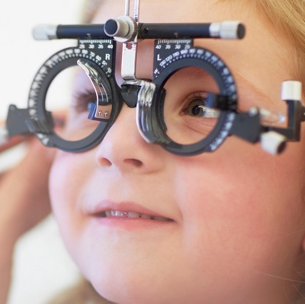 Eye doctor examining girl's vision