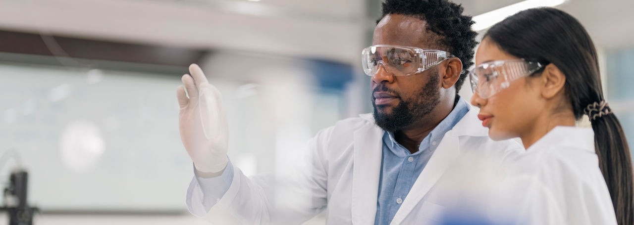 Scientists Working in Modern Medical Research Laboratory. Scientist Analysing Biochemicals Samples. Advanced Scientific Lab for Medicine, Microbiology Development.