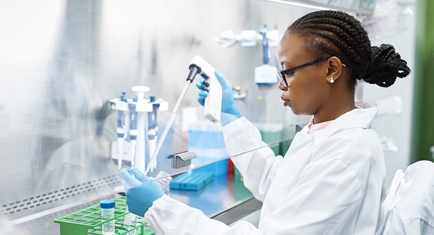  Female scientist extracting substance from test tube