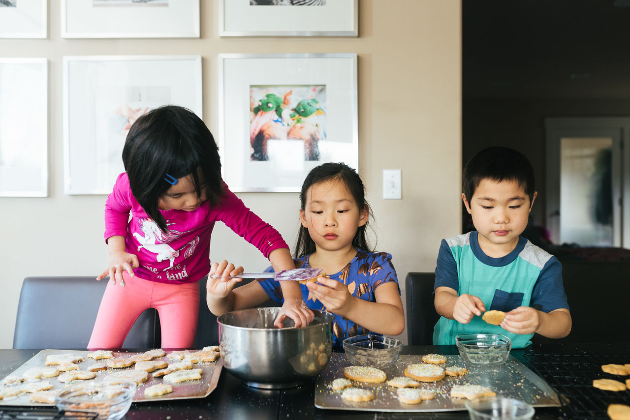 Three siblings making cookies together; Shutterstock ID 1954490038; purchase_order: Masterbrand - Loop 4; job: ; client: ; other: 