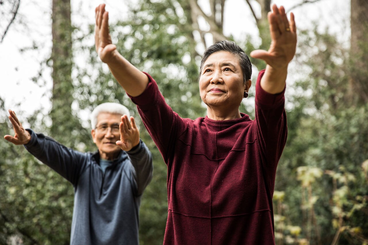 Senior couple doing Tai Chi outdoors