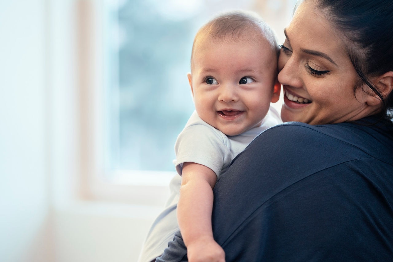 Mother and baby boy playing at home